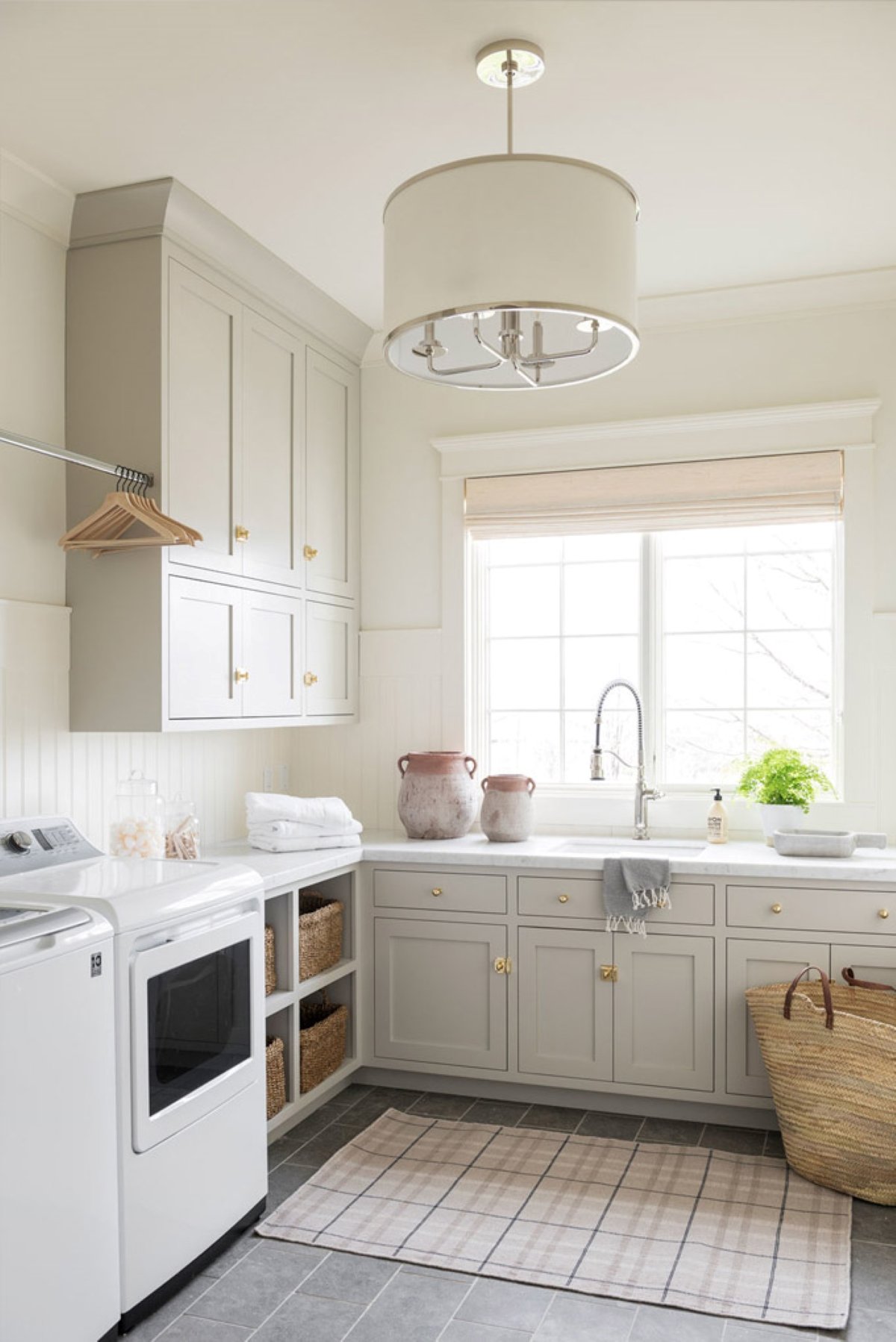 A laundry room with cabinets painted in Benjamin Moore Revere Pewter.