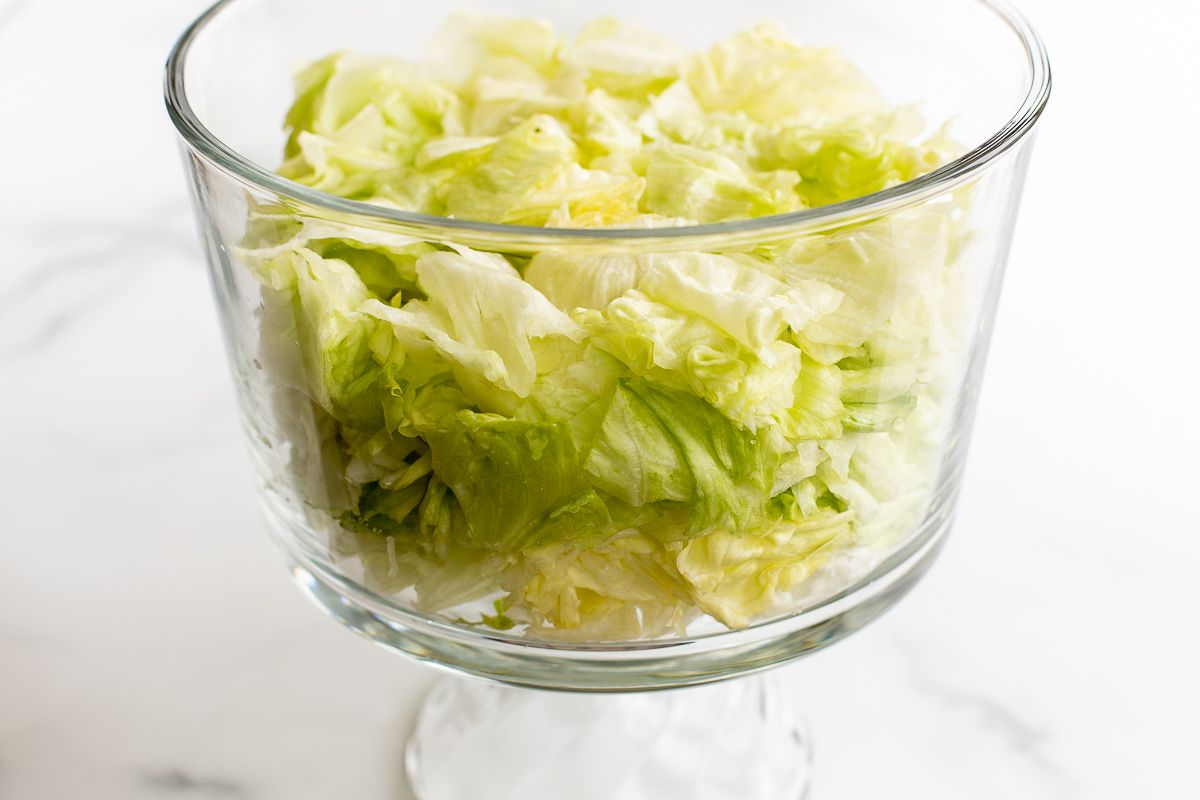 Chopped lettuce in a glass serving dish.