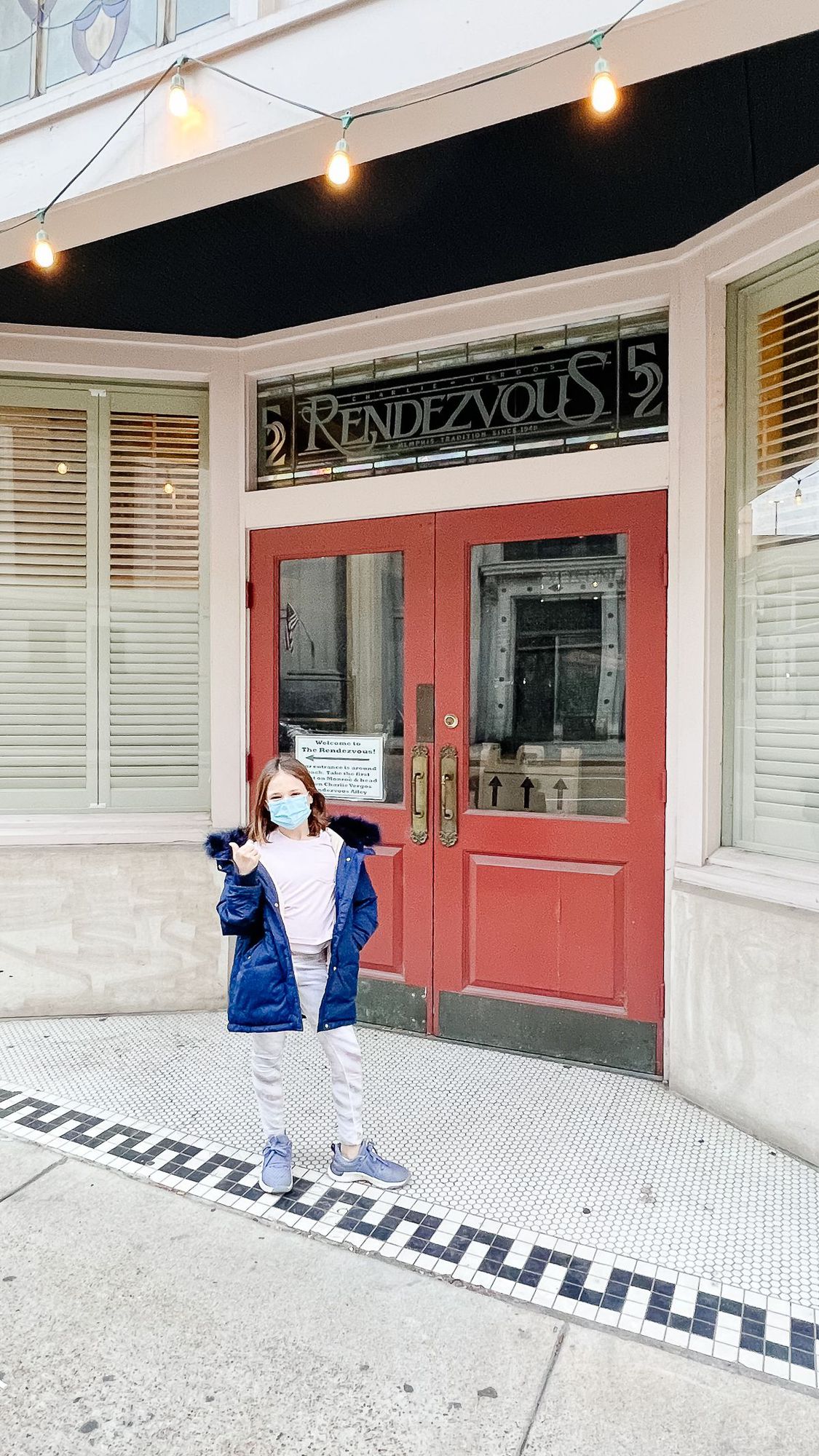 A girl in front of the doors of a famous Memphis Tennessee historic building