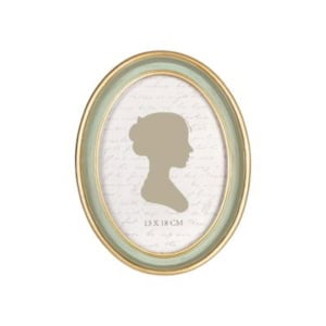 Oval picture frame with a gold and light blue border, perfect for nightstand decorating, displaying a silhouette of a woman's profile on a background with cursive writing. The frame dimensions read "13 x 18 cm.