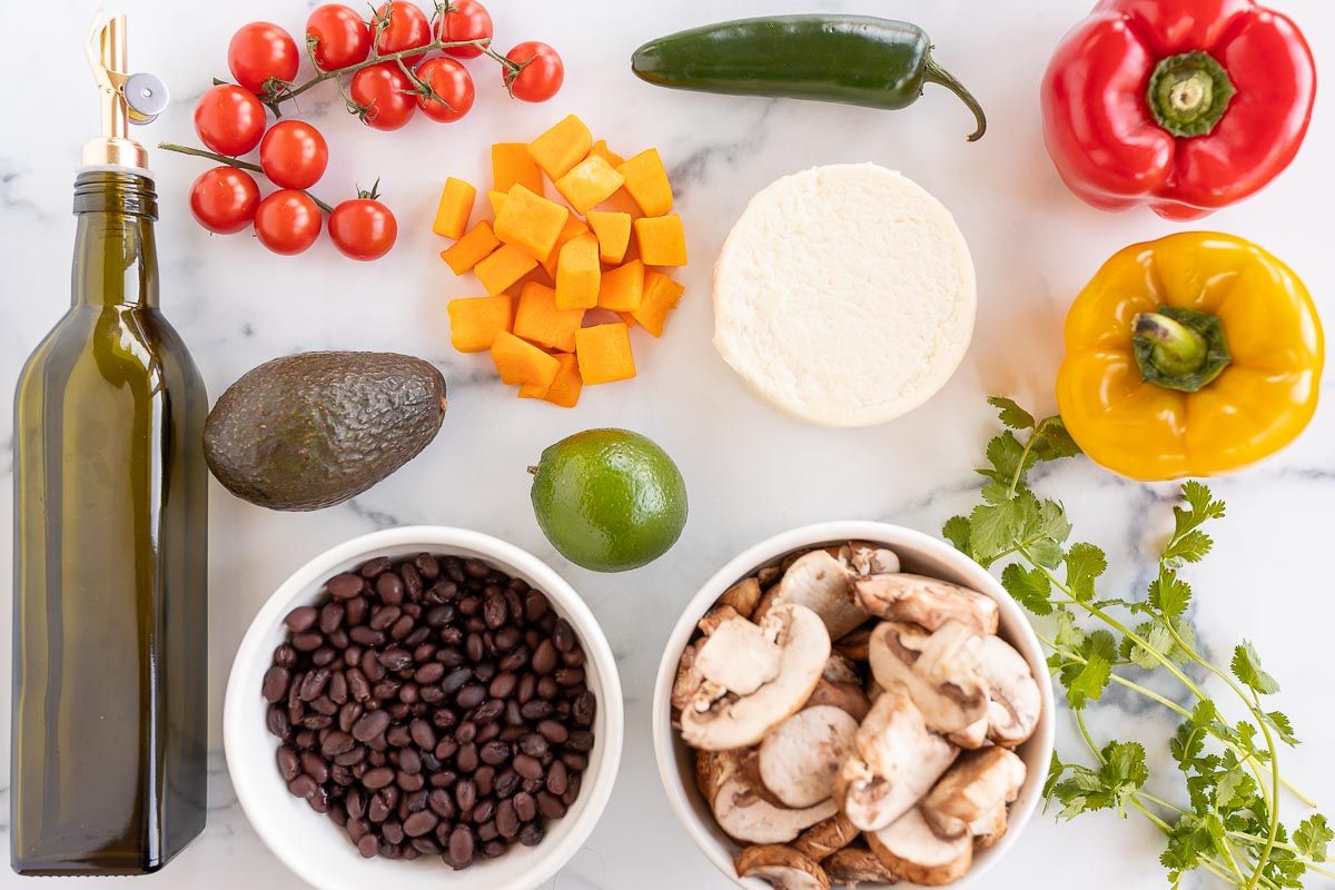 Ingredients for veggie tacos laid out on a white surface