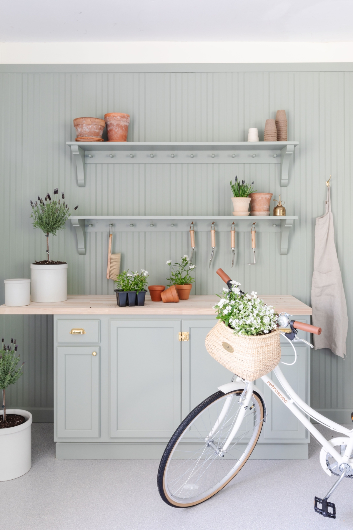 A garage with a green potting table and a