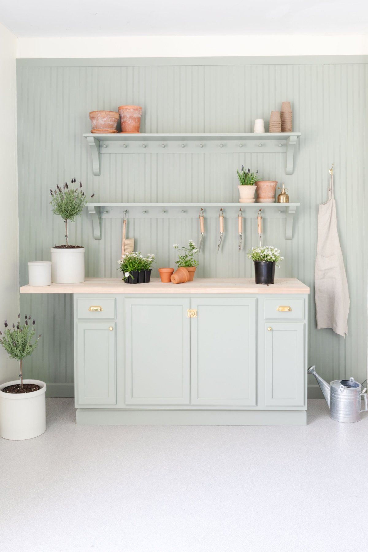 A garage with a green potting table and a