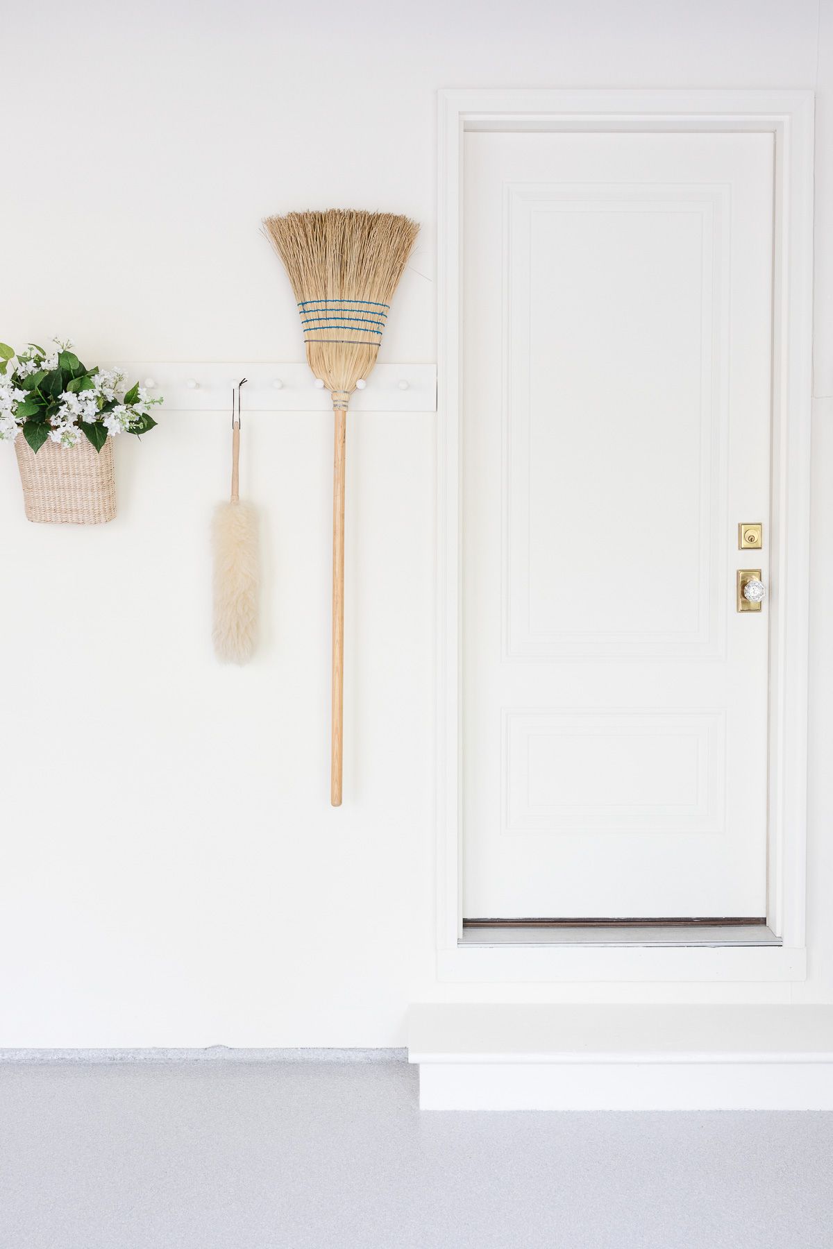 White painted garage entrance with multi-directional garage floor covering