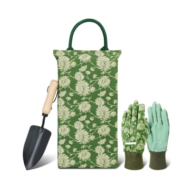 A floral kneeling mat for gardening, with a shovel and garden gloves