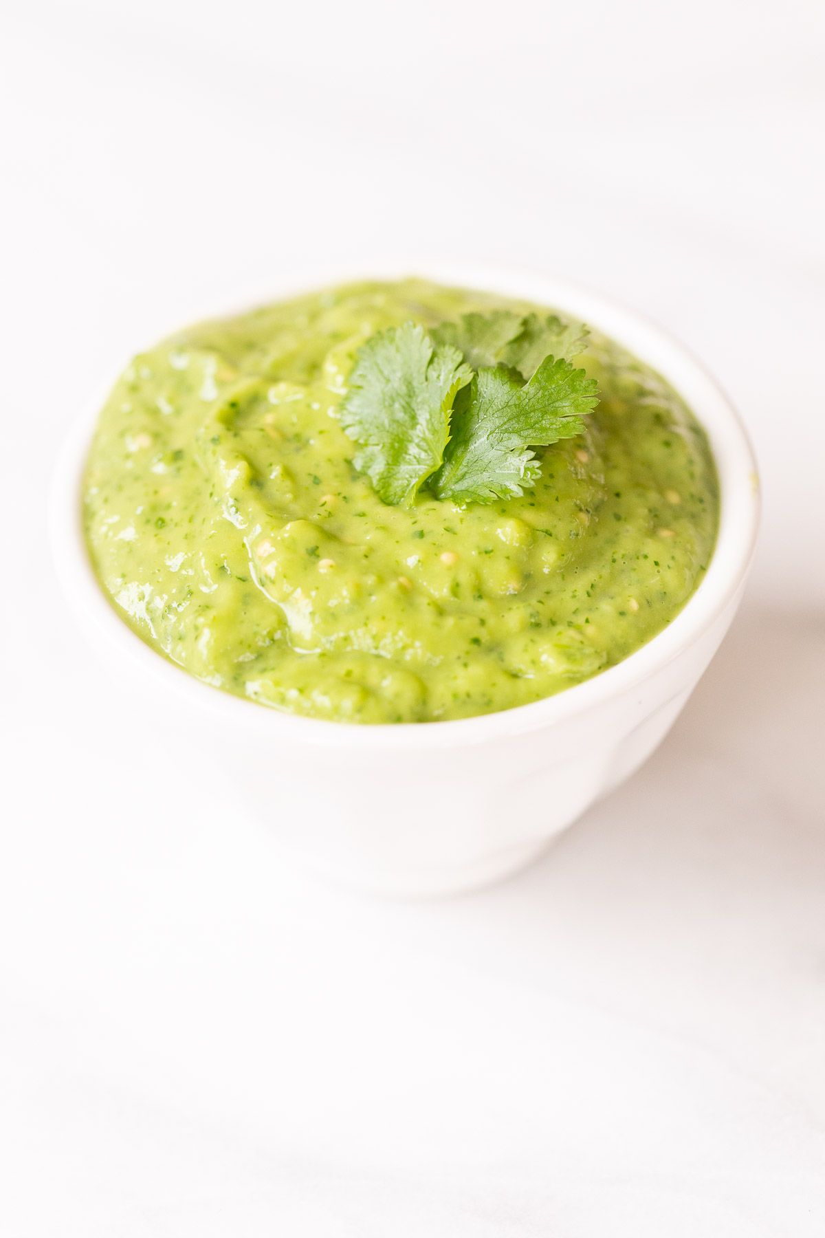 Salsa guacamole in a white bowl as a healthy appetizer