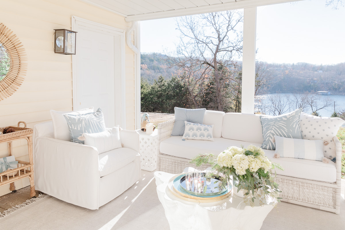 an outdoor patio with serena and lily furniture and a light colored indoor outdoor rug