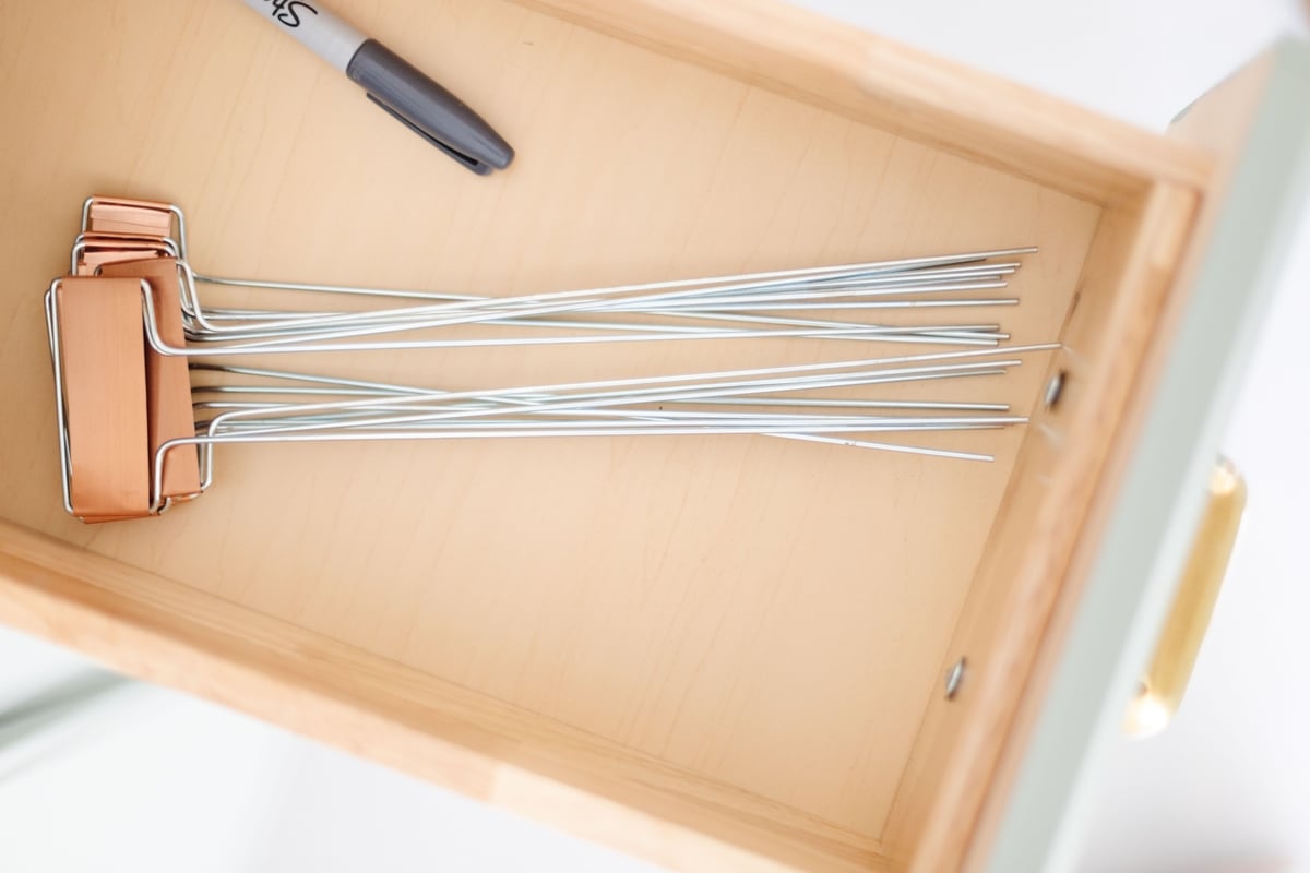 Inside the drawer of a potting bench, garden markers