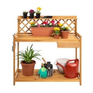 A potting bench with pots and gardening tools.