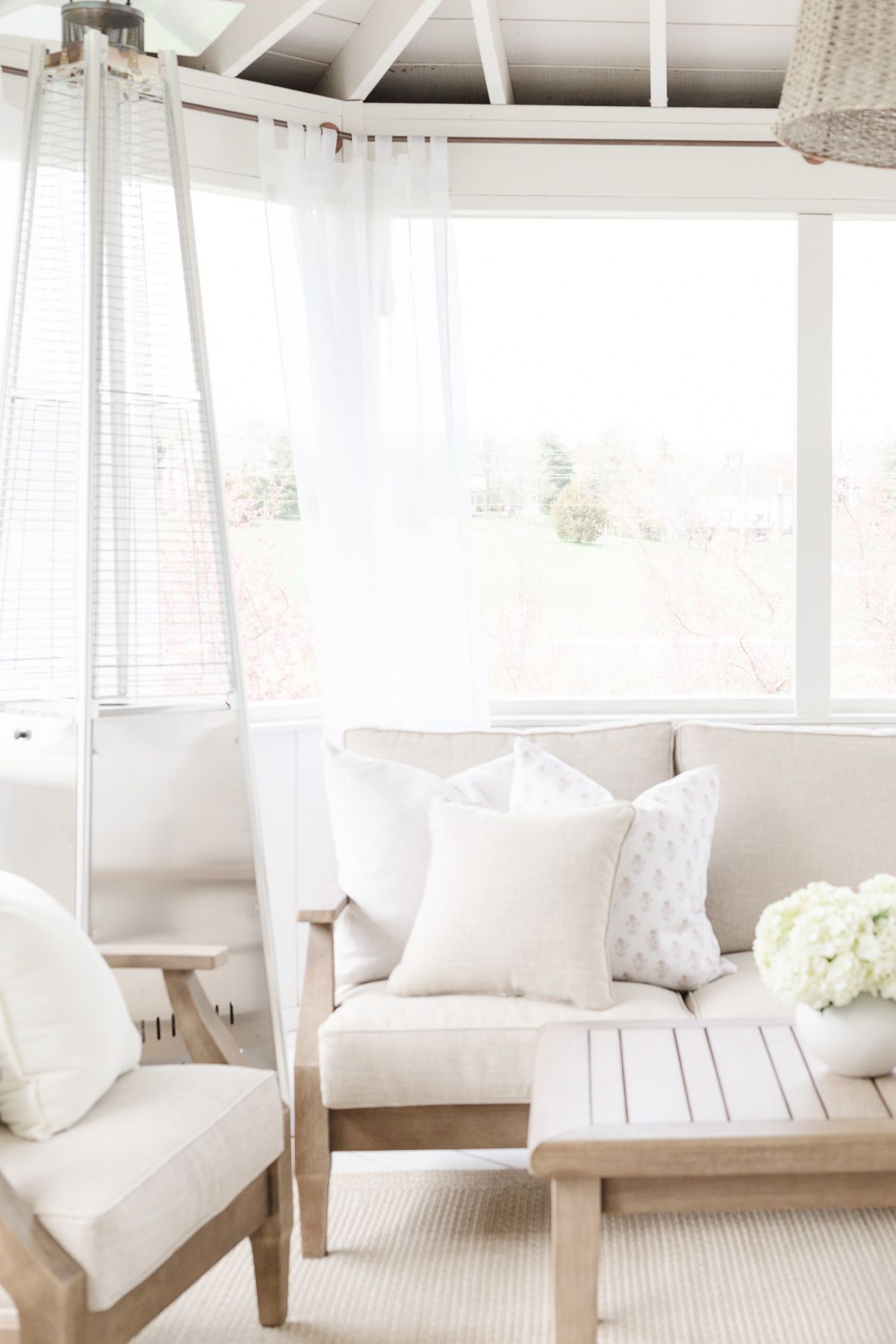 A white screened porch completed with a screened porch kit.