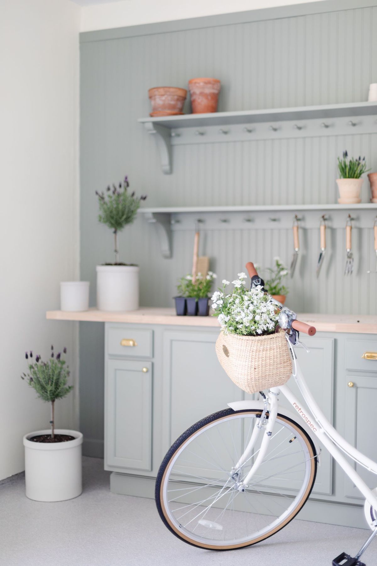 A green built in potting bench painted in Sherwin Williams Evergreen Fog