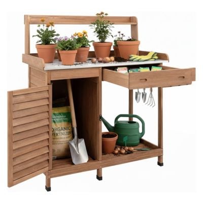 This wooden potting bench showcases potting benches at their best, with potted flowers, gardening tools, gloves, a watering can, fertilizer, bulbs, and a shovel neatly organized on and inside the bench.