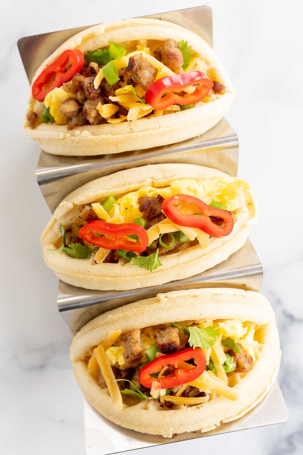 waffle tacos in a stainless steel taco holder.