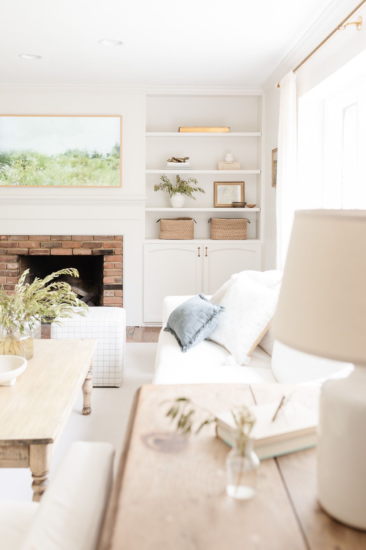 A white living room with a wood coffee table