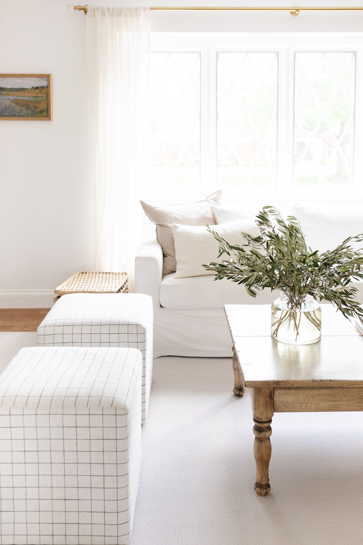 A white living room with a wood coffee table