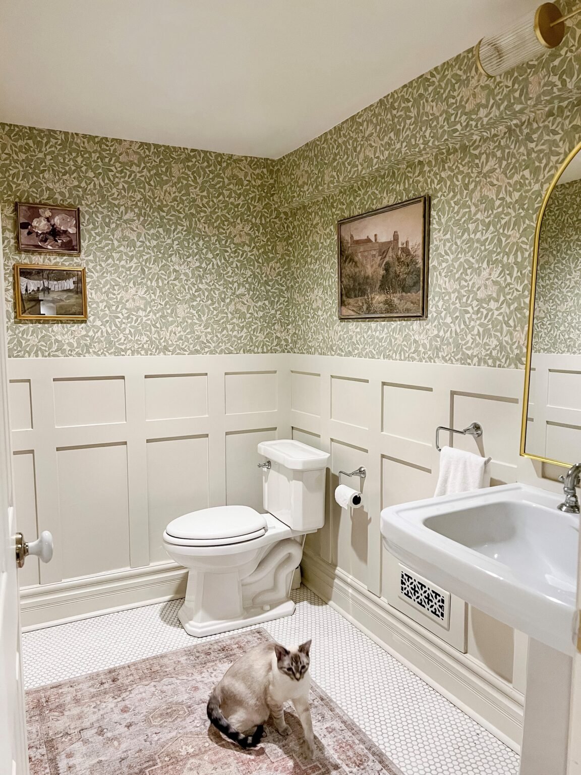 A partitioned bathroom with planks and tiles at the bottom of the walls, painted Natural Cream Benjamin Moore.