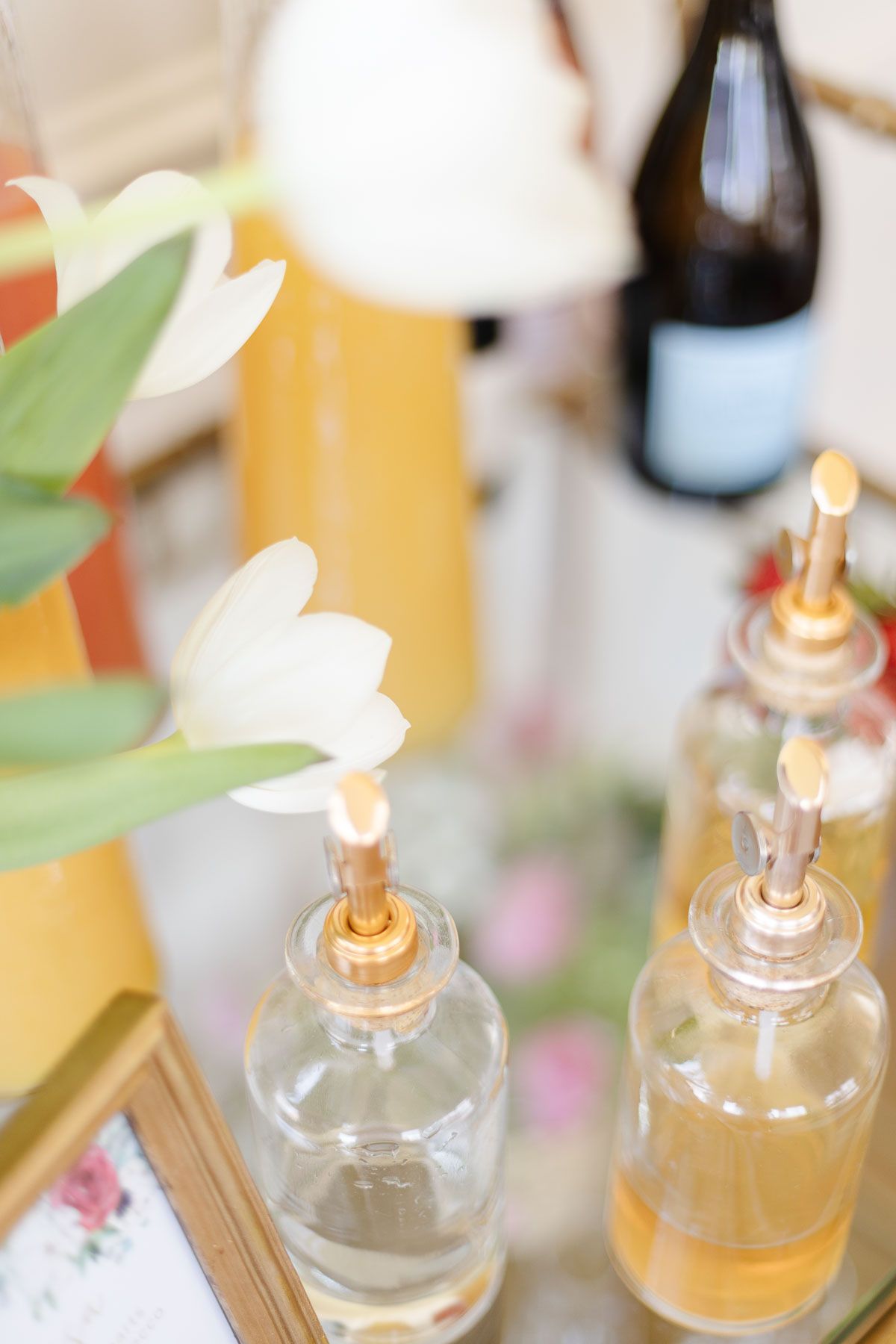 mimosa bar ideas with white tulips and fresh juices in glass bottles