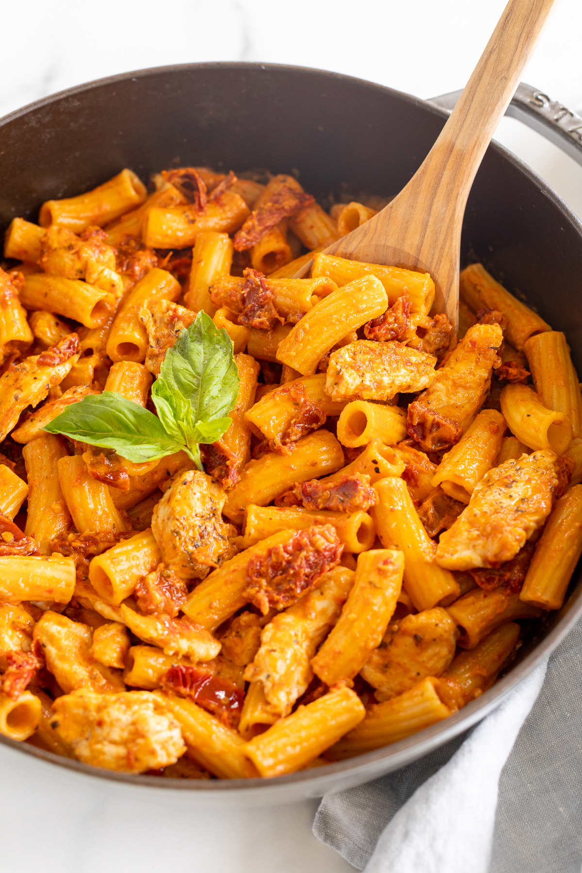 A saute pan filled with a sundried tomato chicken pasta recipe