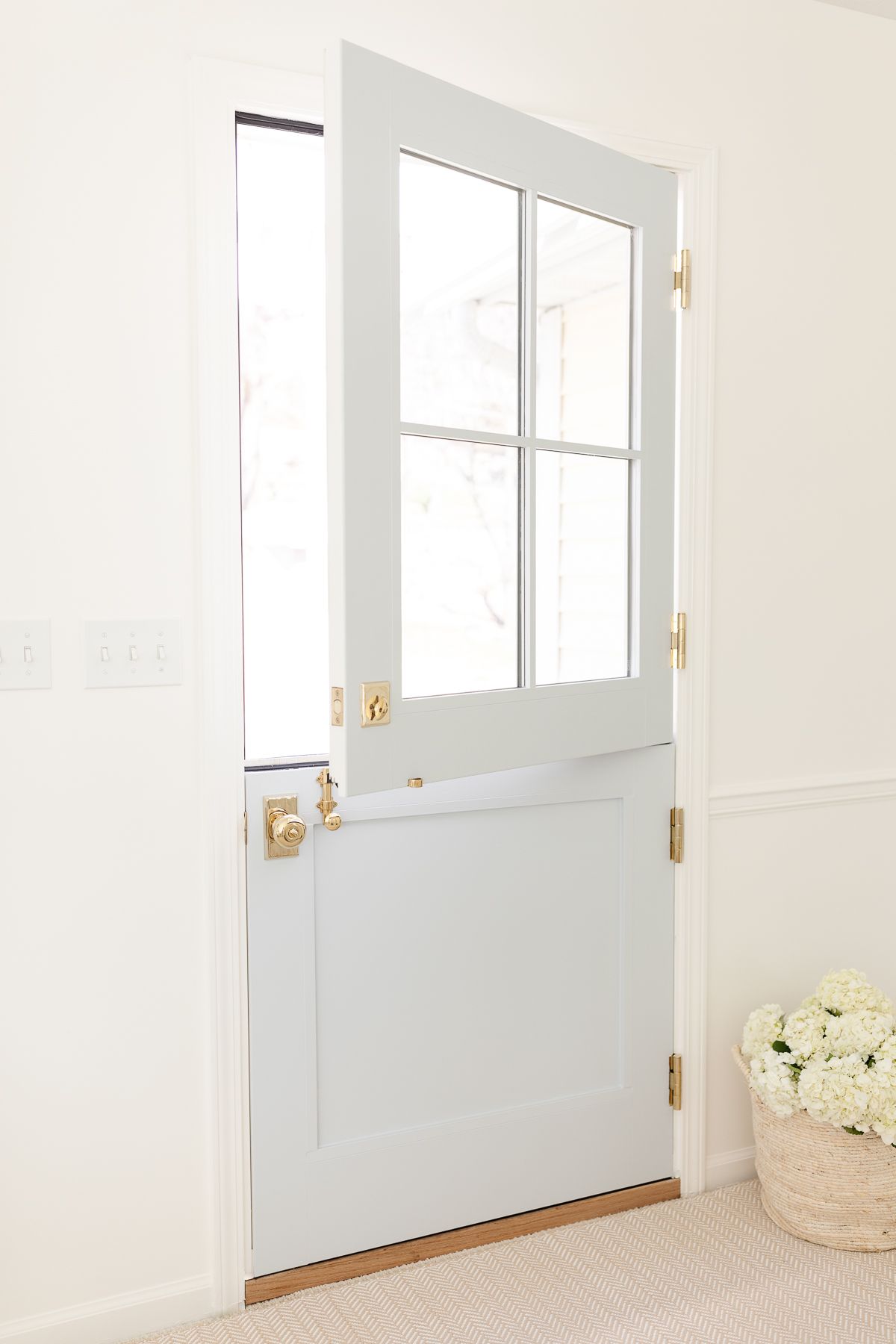 A blue dutch door with brass hardware paint blue without sanding