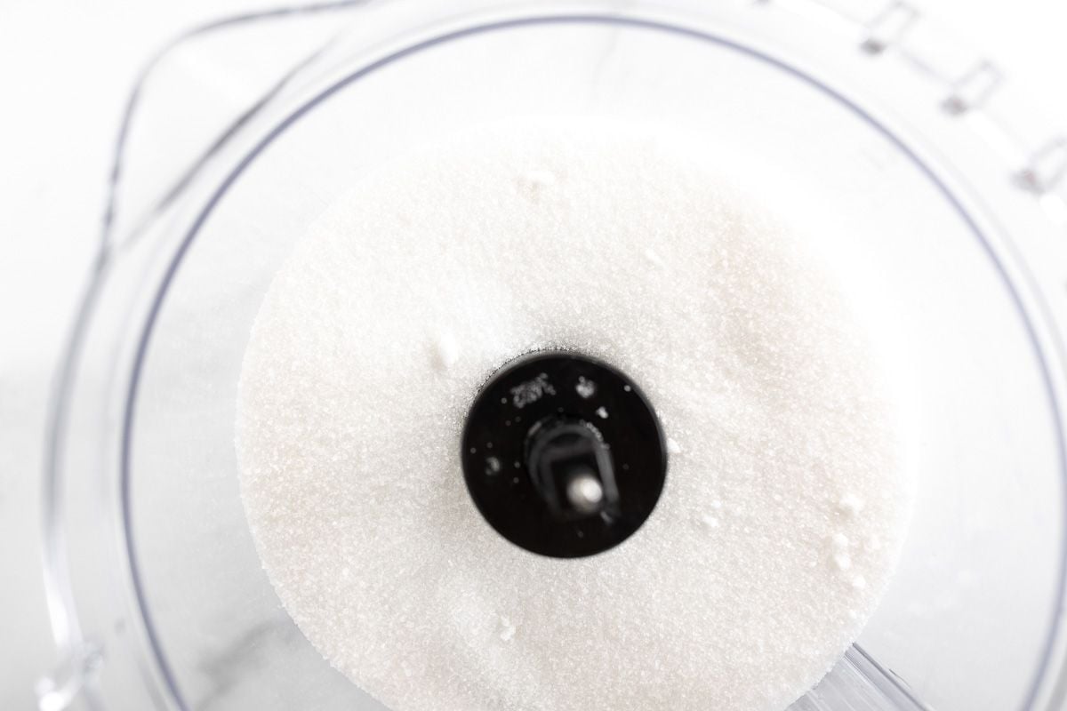 homemade powdered sugar inside the bowl of a food processor