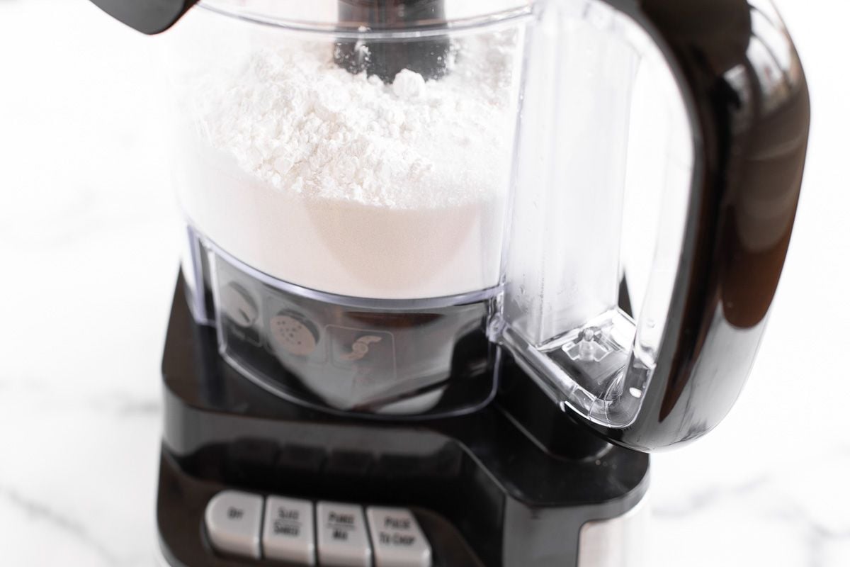 homemade powdered sugar inside the bowl of a food processor