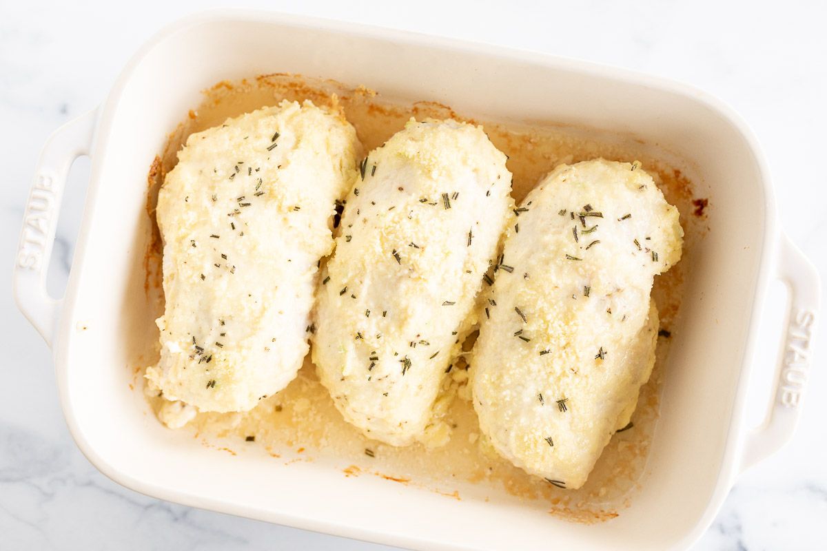 Mayo Parmesan chicken breasts baked in a white dish.