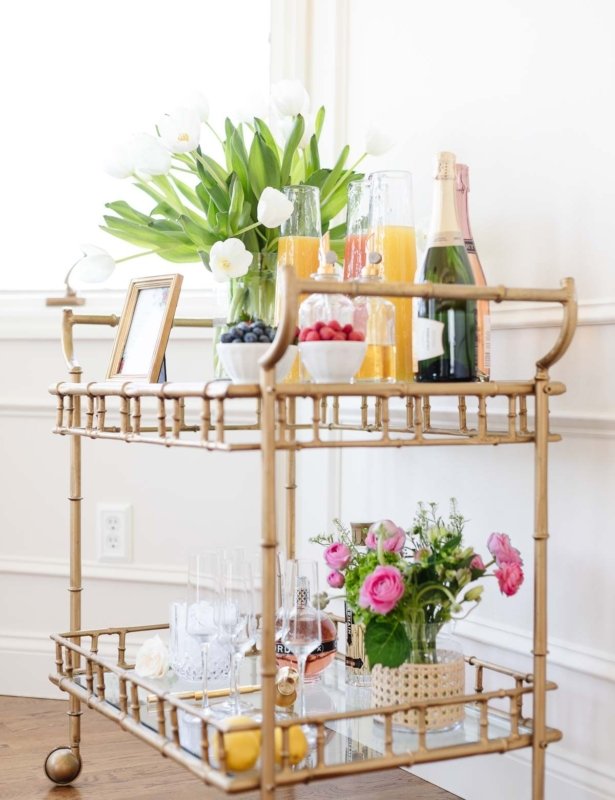 A mimosa bar set up on a gold bar cart