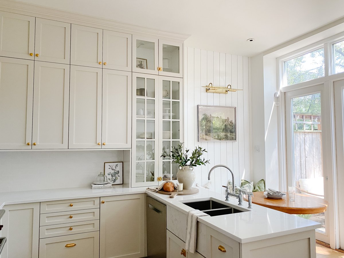 A kitchen with a mushroom paint color on the cabinets