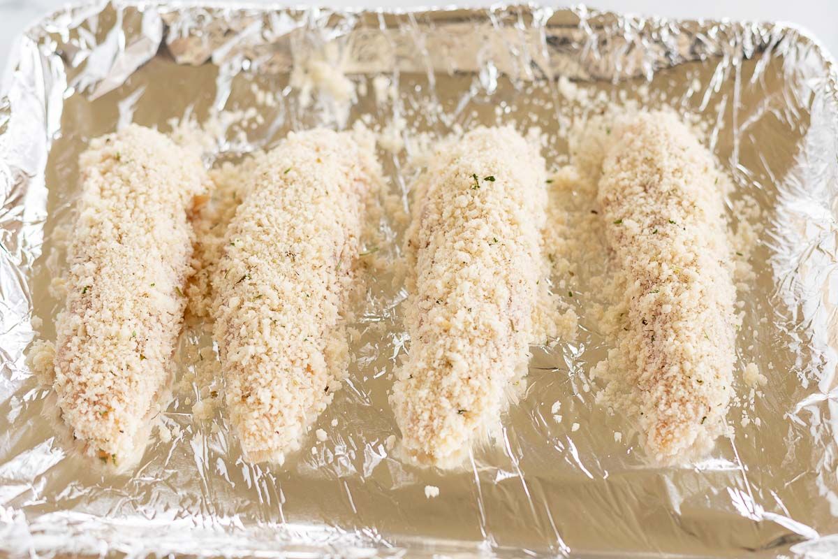 baked panko chicken on a foil lined baking sheet before cooking