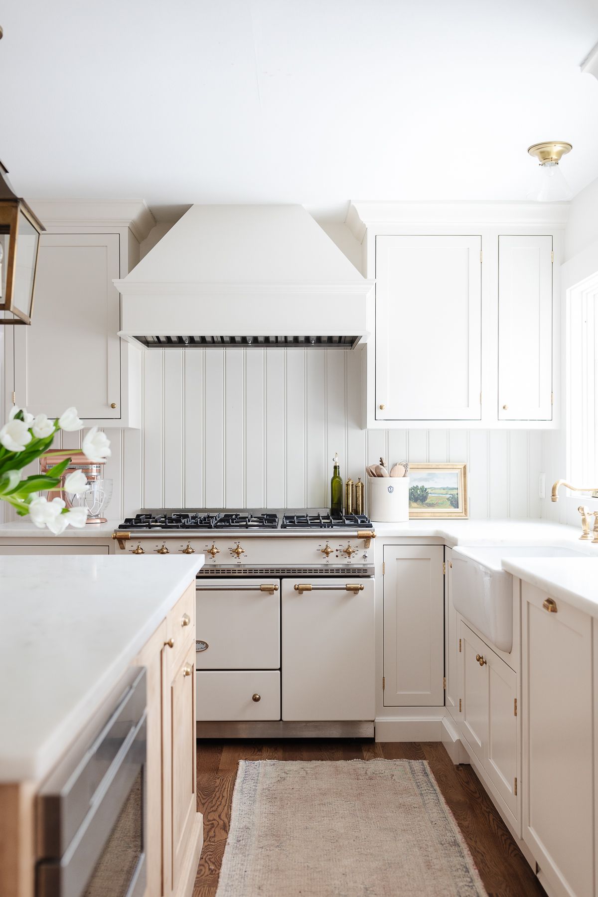 Cream kitchen with traditional rug on hardwood floors