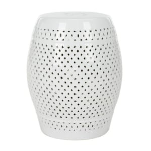 A white ceramic garden stool with holes.
