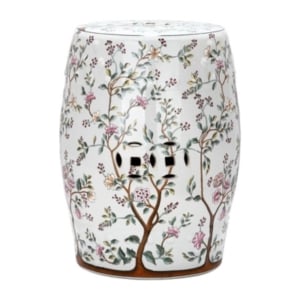A white ceramic stool with a floral design.