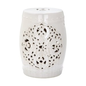 This white ceramic garden stool features an ornate design.