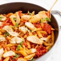 Chorizo and chicken pasta in a cast iron skillet.