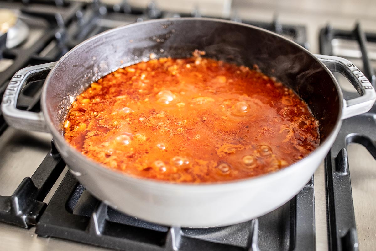 tomatoes in a cast iron skillet on a stove top