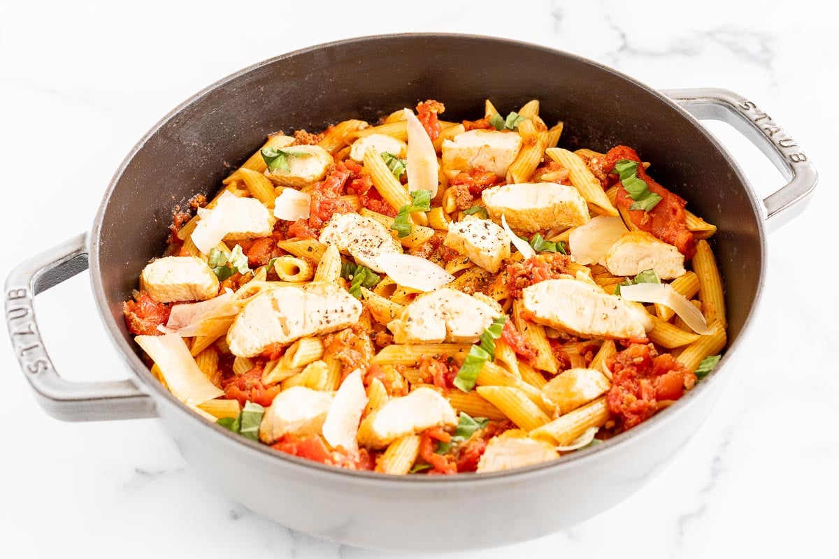 Chorizo and chicken pasta in a cast iron skillet.