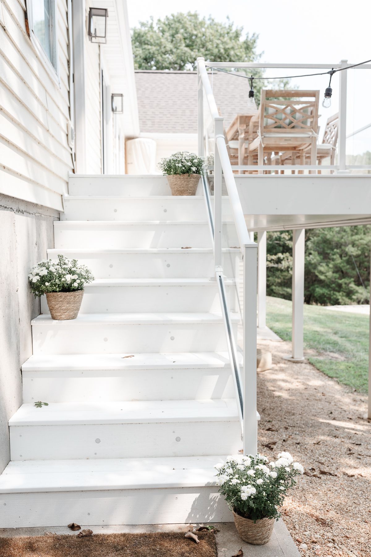 White vinyl deck stairs with discreet deck lighting on every other step.
