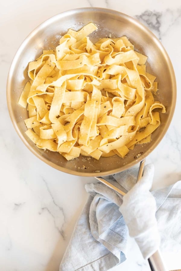 buttered garlic parmesan pasta in a silver pan