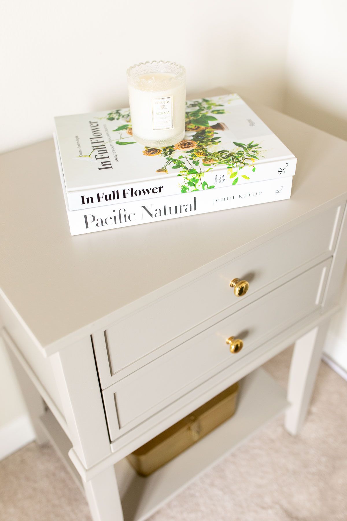 A small side table painted in a mushroom color