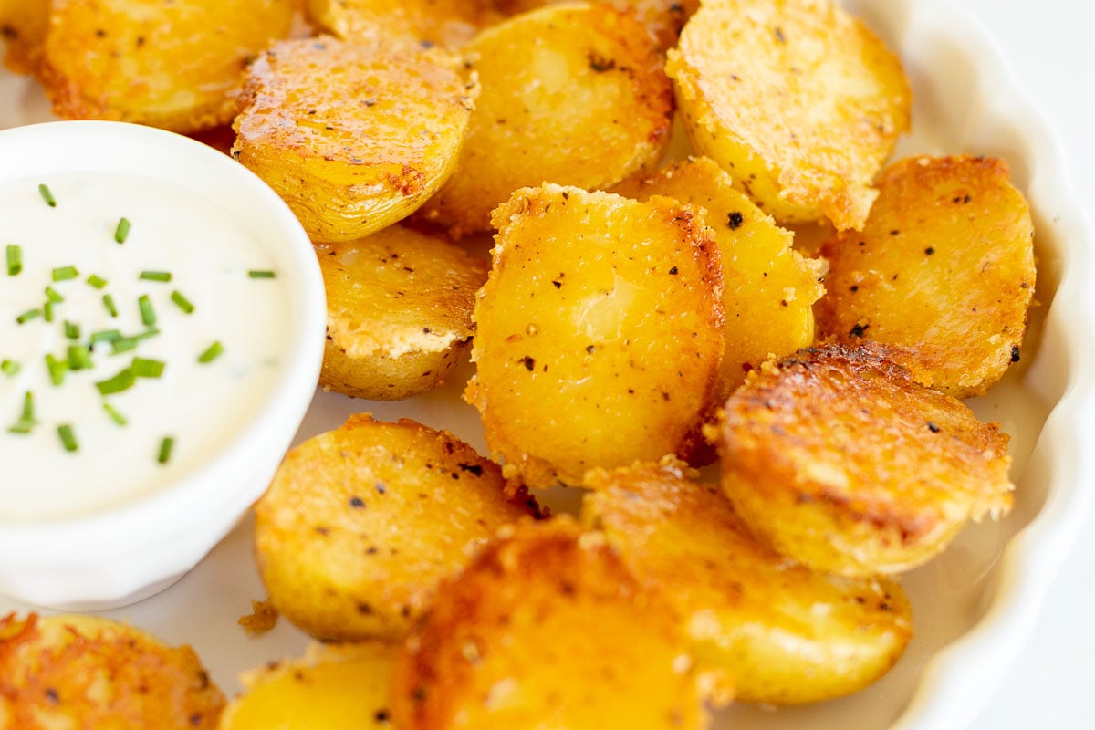 A delectable plate of potato wedges served with a dip, showcasing the versatility of potato side dishes.