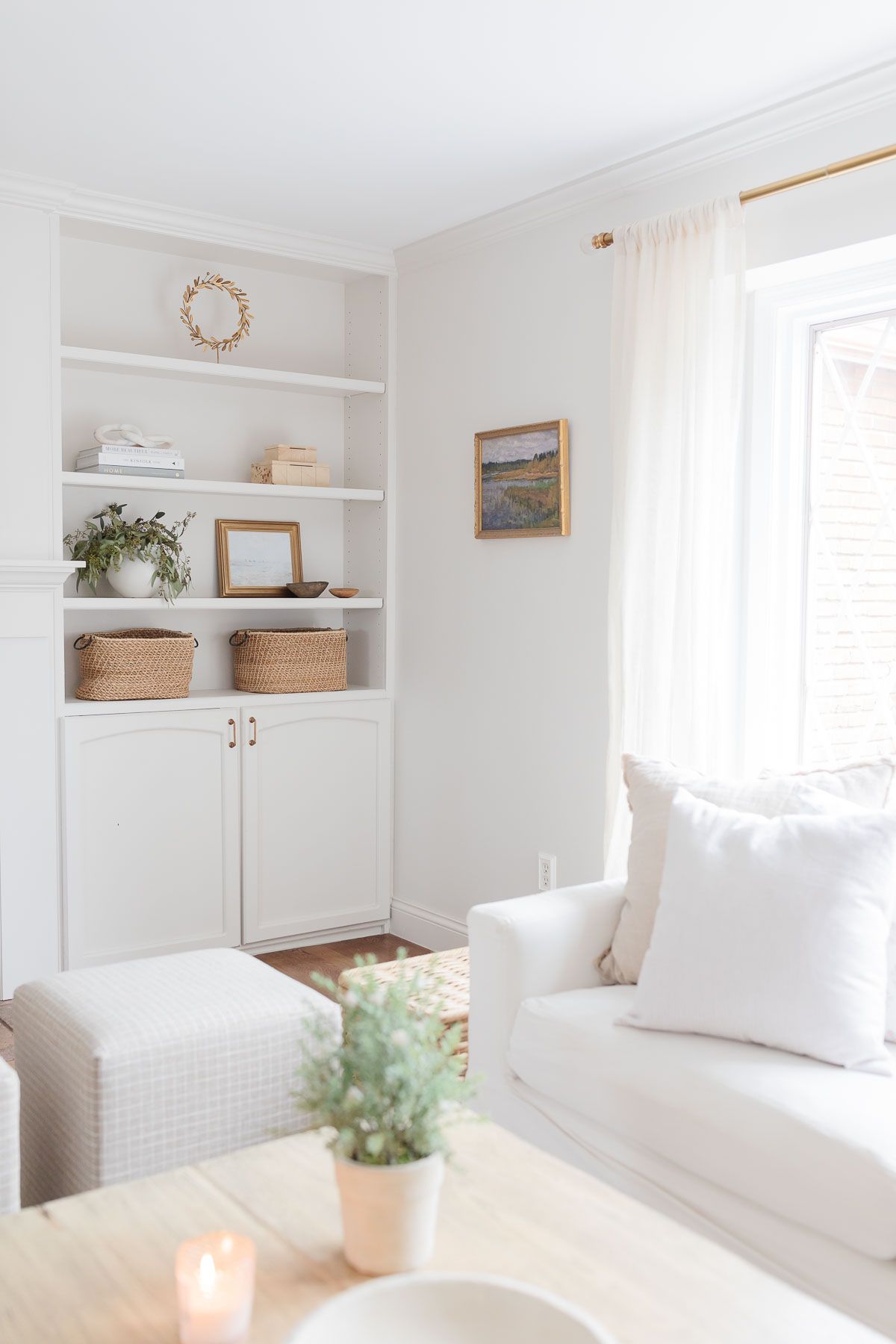 A white living room with two white slipcovered sofas