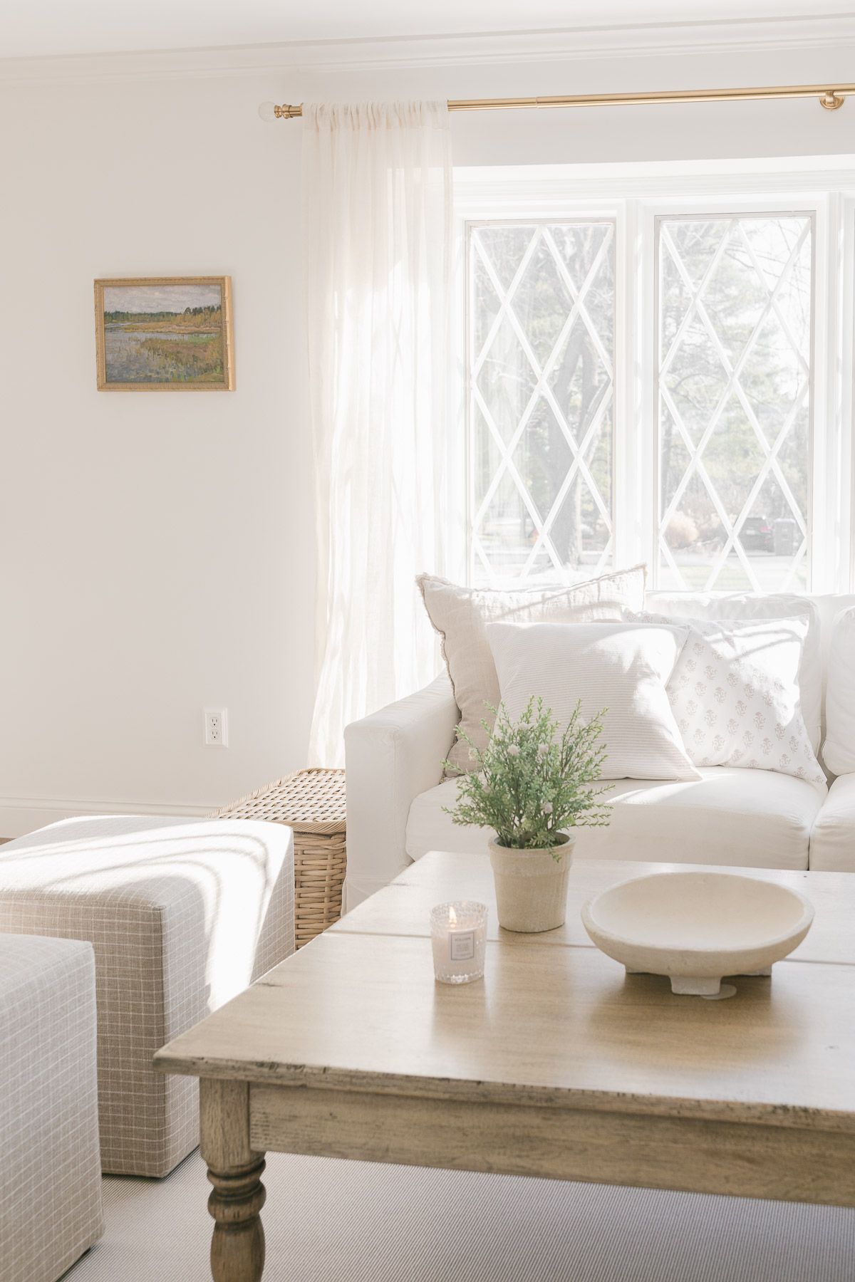 A white living room with two white slipcovered sofas