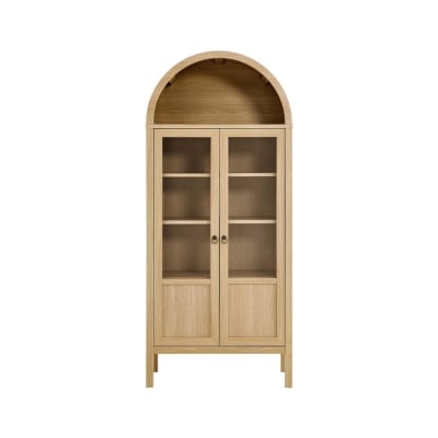 A wooden display cabinet with a rounded top, glass-paneled double doors, and three shelves, standing on four legs. Ideal for achieving that Arhaus look for less.