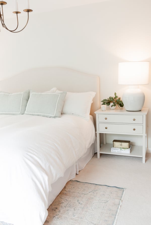A white bed in a bedroom, designed with an Arhaus look for less.