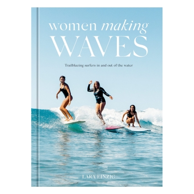 A blue coffee table book called "girls making waves" with female surfers in the cover image