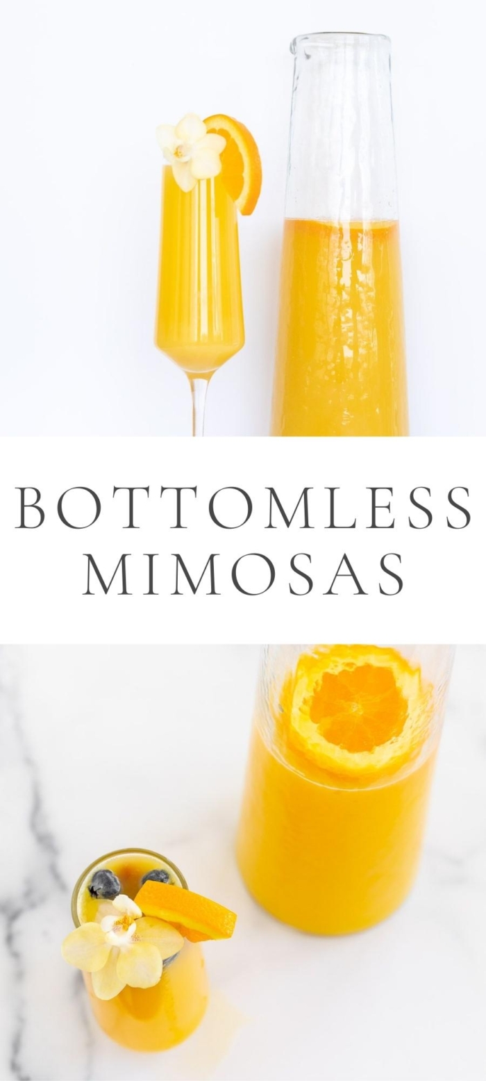 orange mimosas in glasses and bottles with flowers lemon and blueberry