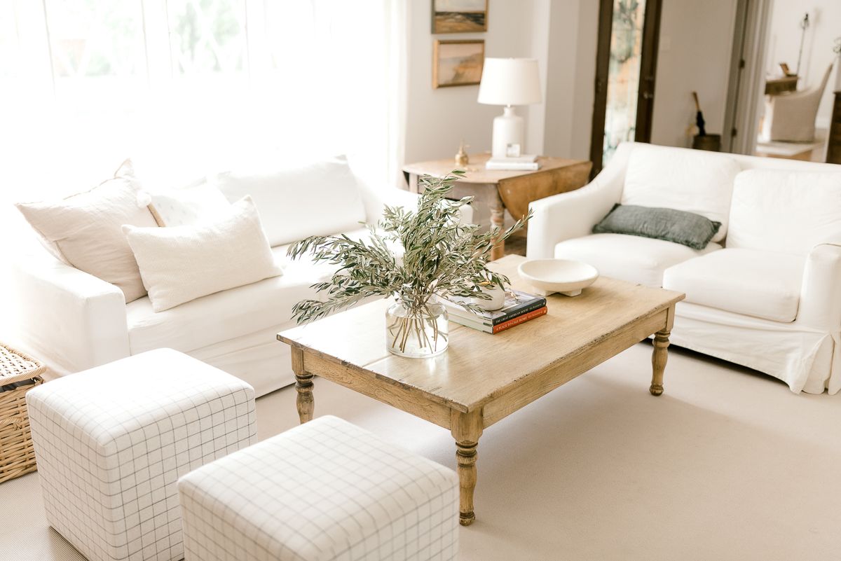 A living room with neutral coffee table decor.