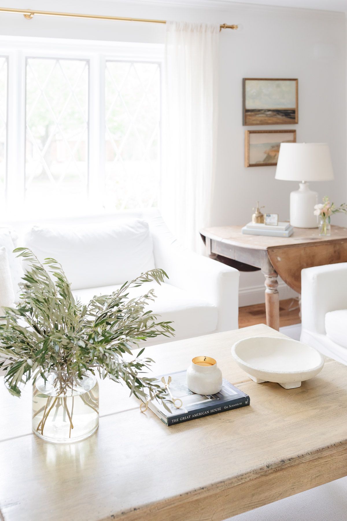 A living room with neutral coffee table decor.