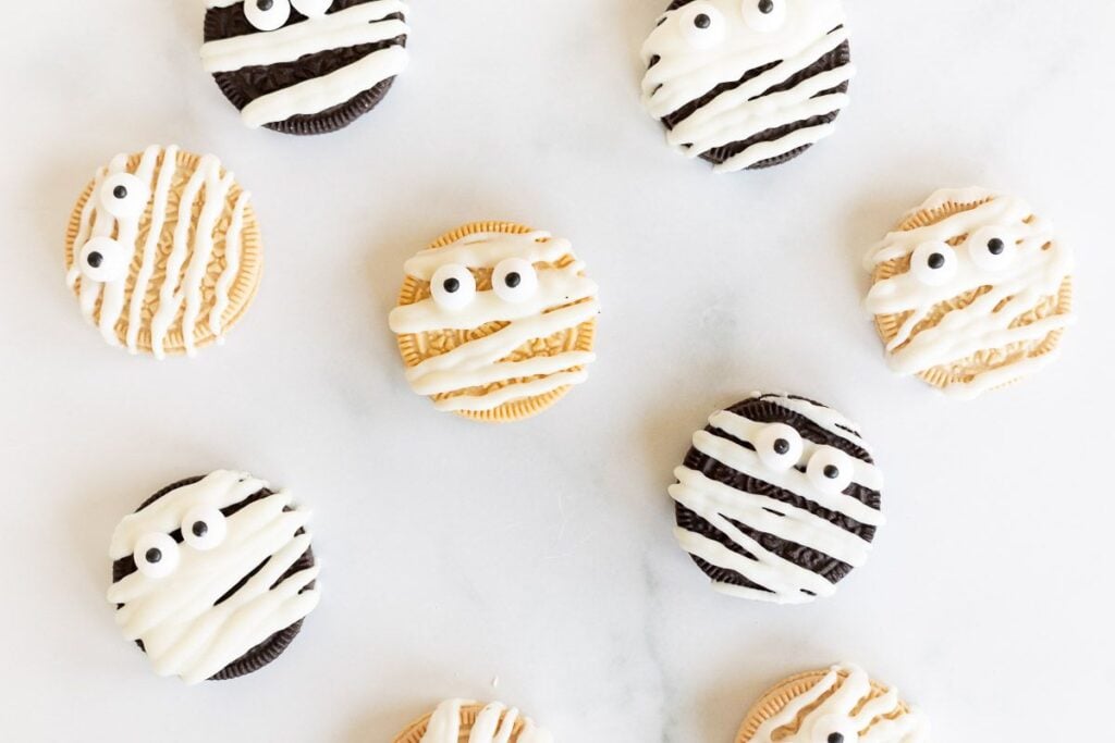 No bake desserts, Oreos decorated as mummies on a white marble surface