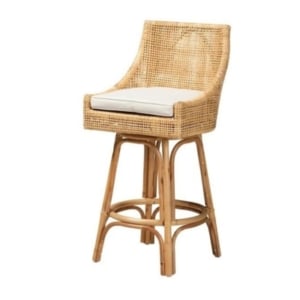 A rattan bar stool with a stylish white cushion.